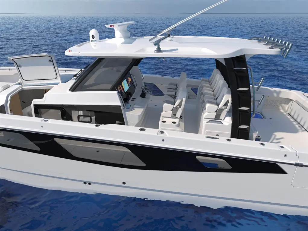 Luxury catamaran cockpit with modern seating, dashboard controls, and an open view of the blue ocean. "LOKAI CATAMARAN" visible.